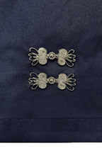 Pair of decorative design on a dark blue fabric background