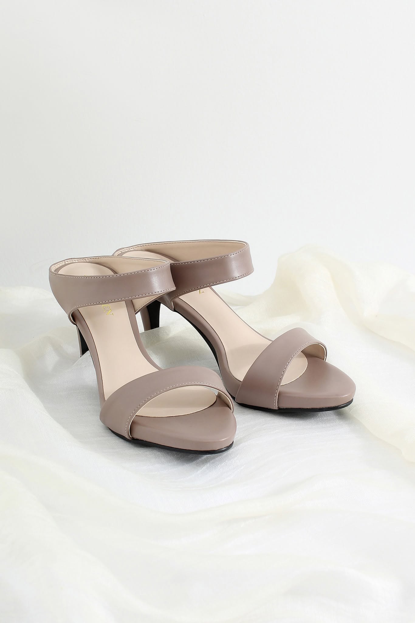 A pair of taupe open-toe slingback high heels with a low block heel