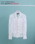 White lace blouse on a hanger against a light blue background