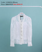 White lace blouse on a hanger against a light blue background
