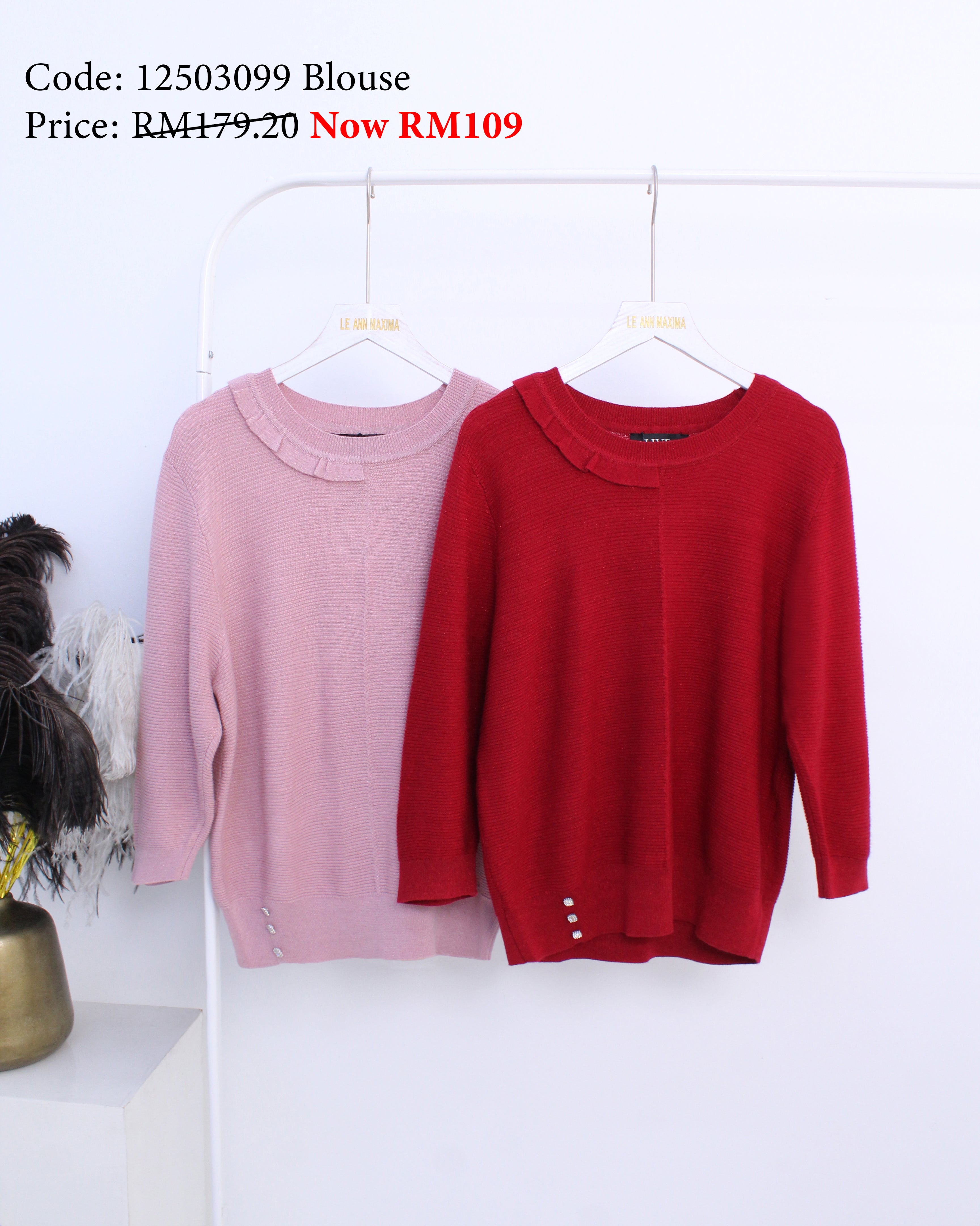 Pink and red blouses on hangers with price tags against a white background