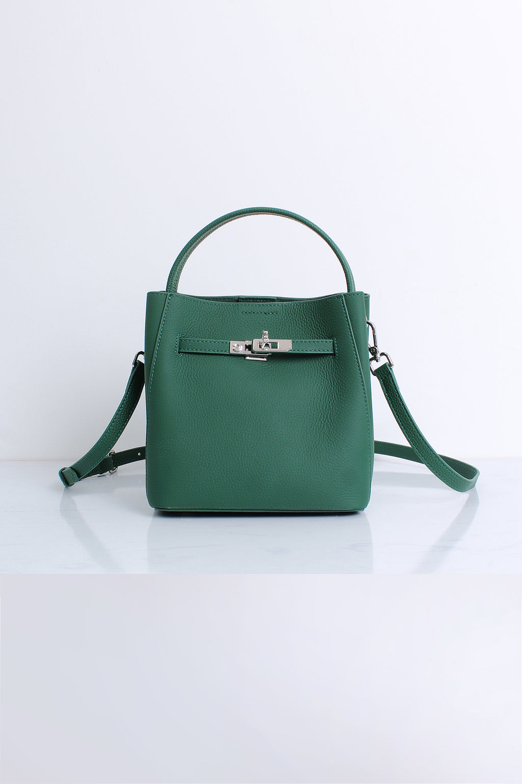 A structured green leather handbag with a top handle, a detachable shoulder strap, and a silver-tone front clasp