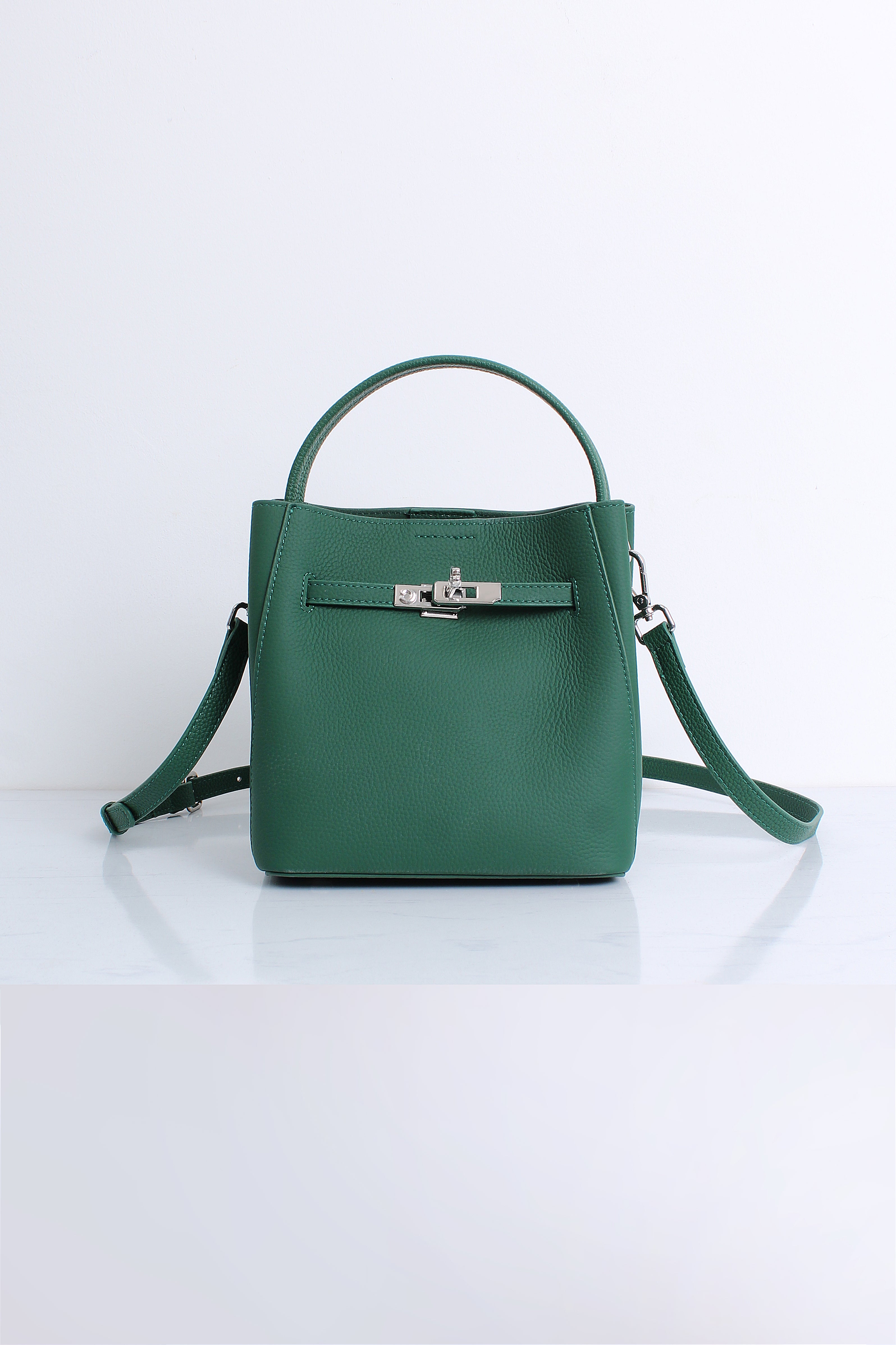 A structured green leather handbag with a top handle, a detachable shoulder strap, and a silver-tone front clasp