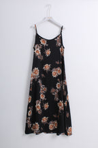 A black spaghetti-strap midi dress with a brown and beige floral pattern