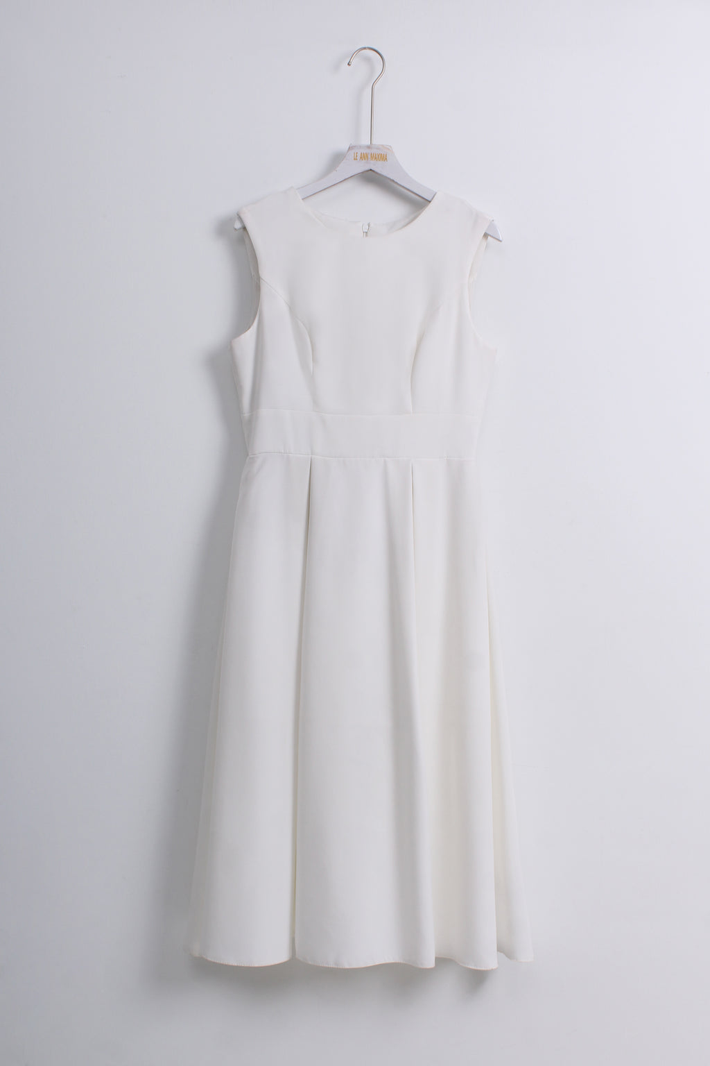 A sleeveless white A-line dress with a structured, slightly padded bodice and a flared skirt.