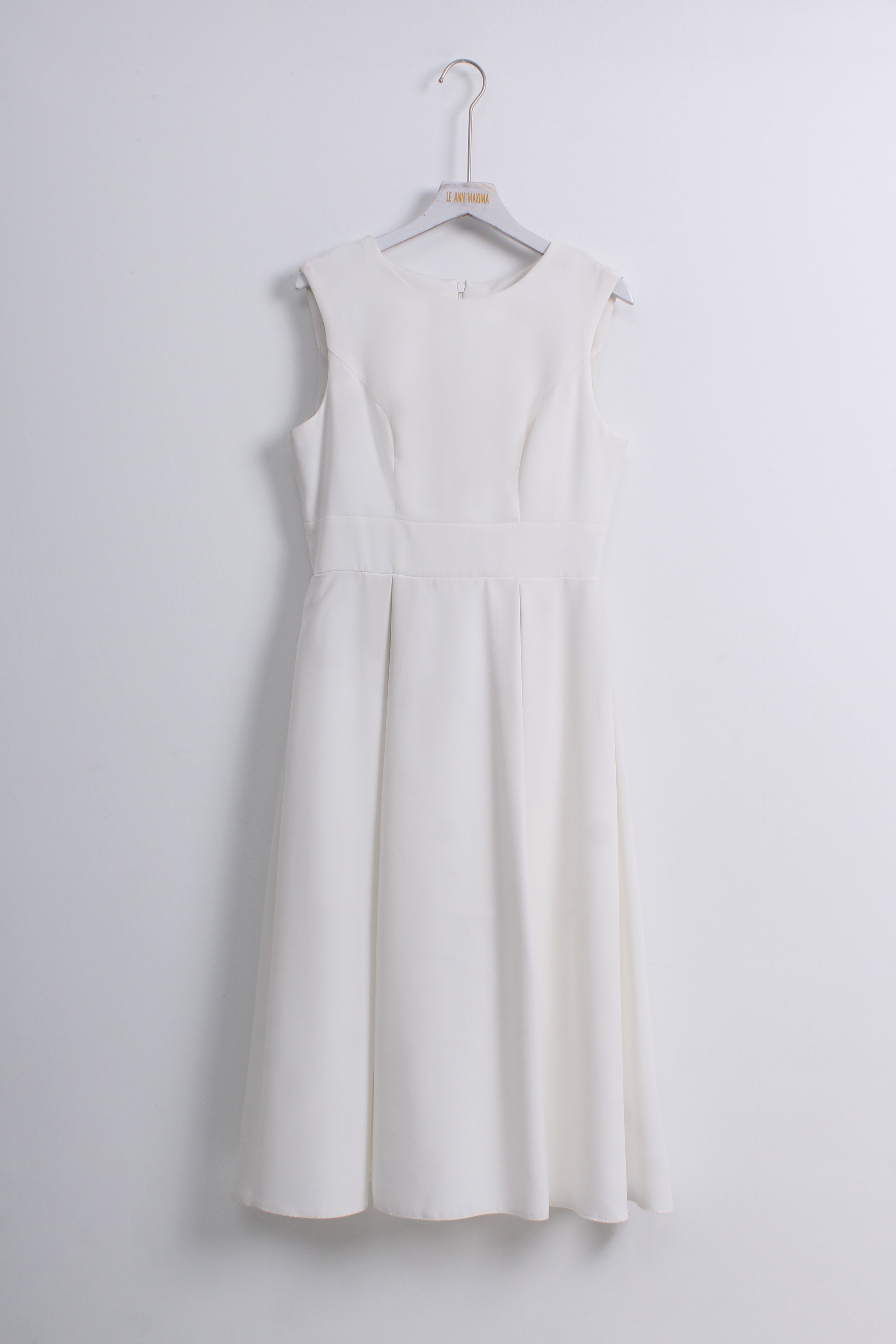 A sleeveless white A-line dress with a structured, slightly padded bodice and a flared skirt.