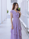 Woman wearing a purple lavender ruffled maxi dress
