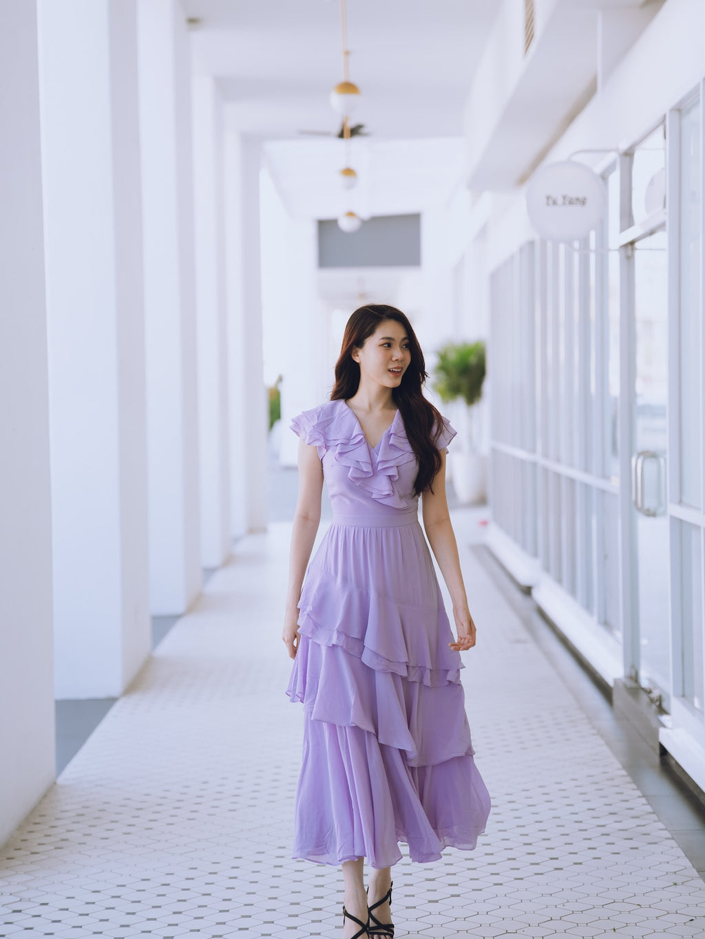 Woman in a lavender purple ruffle dress