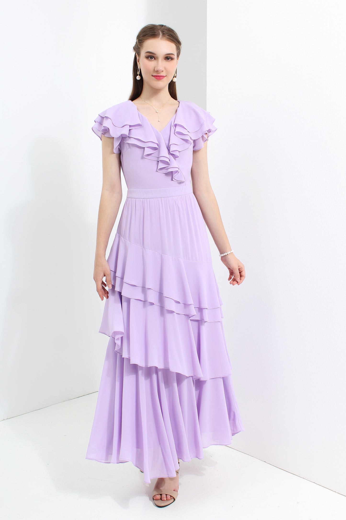 Woman wearing a purple dress with ruffled top and layered skirt