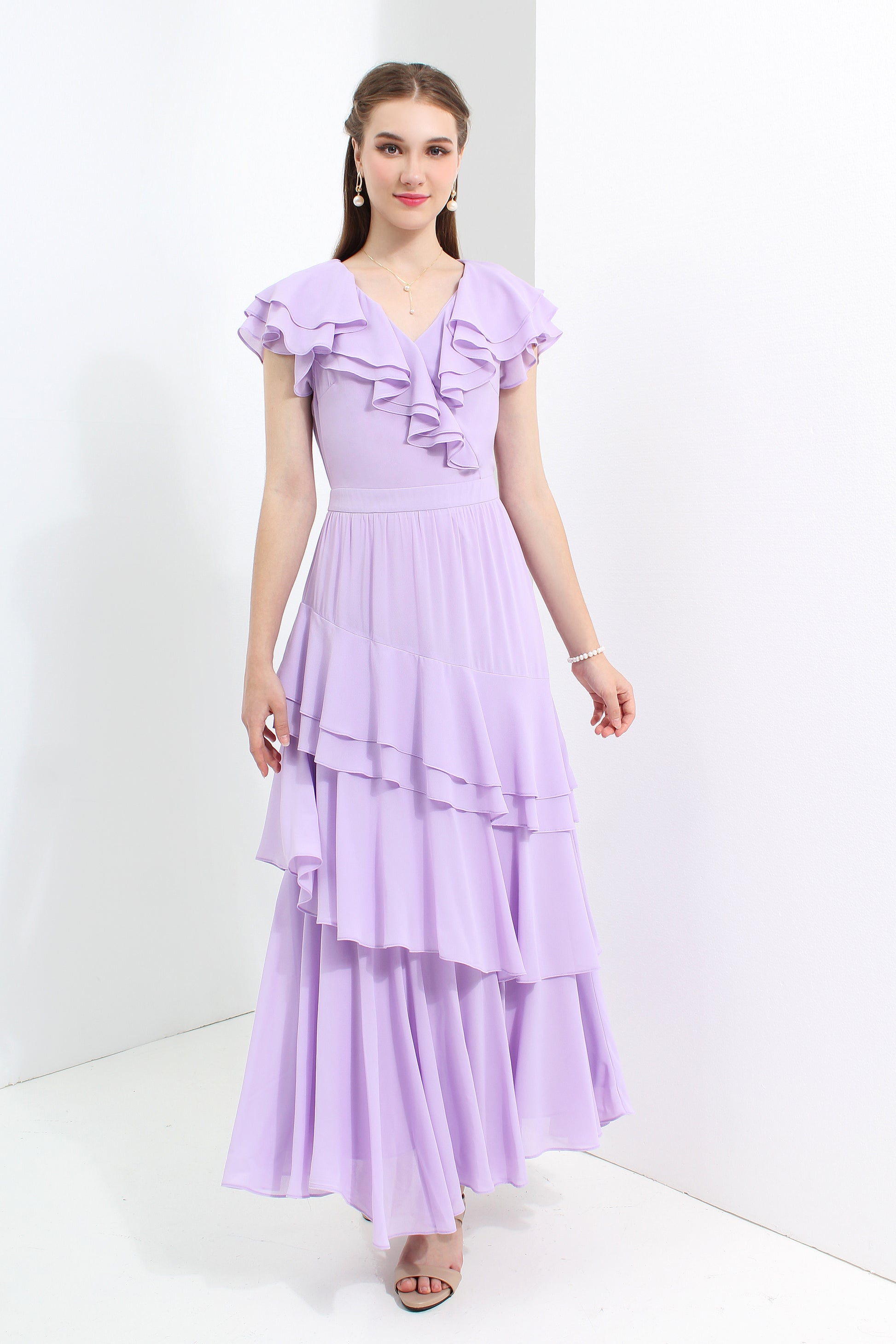 Woman wearing a purple dress with ruffled top and layered skirt