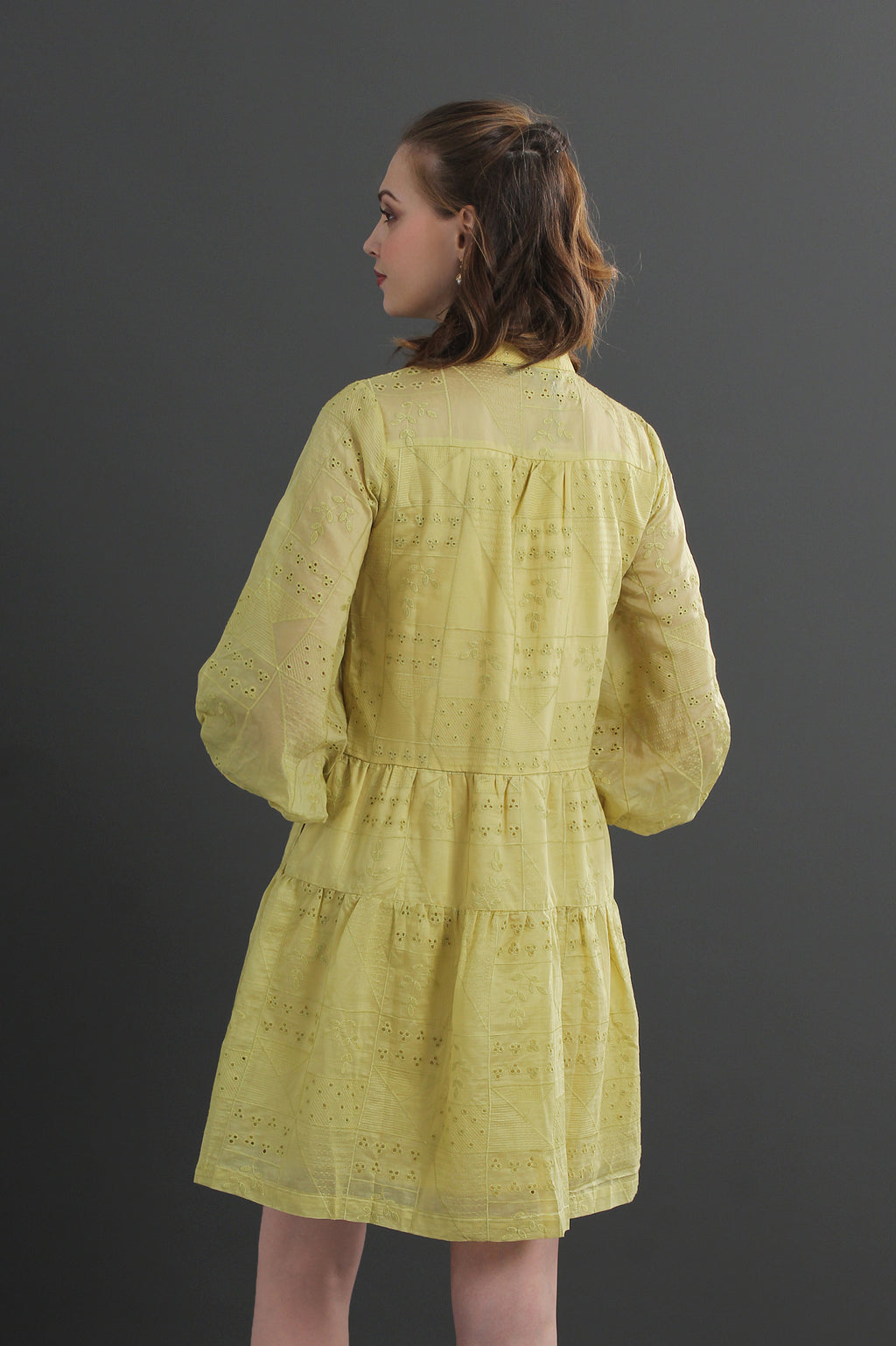 Woman wearing an eyelet yellow dress