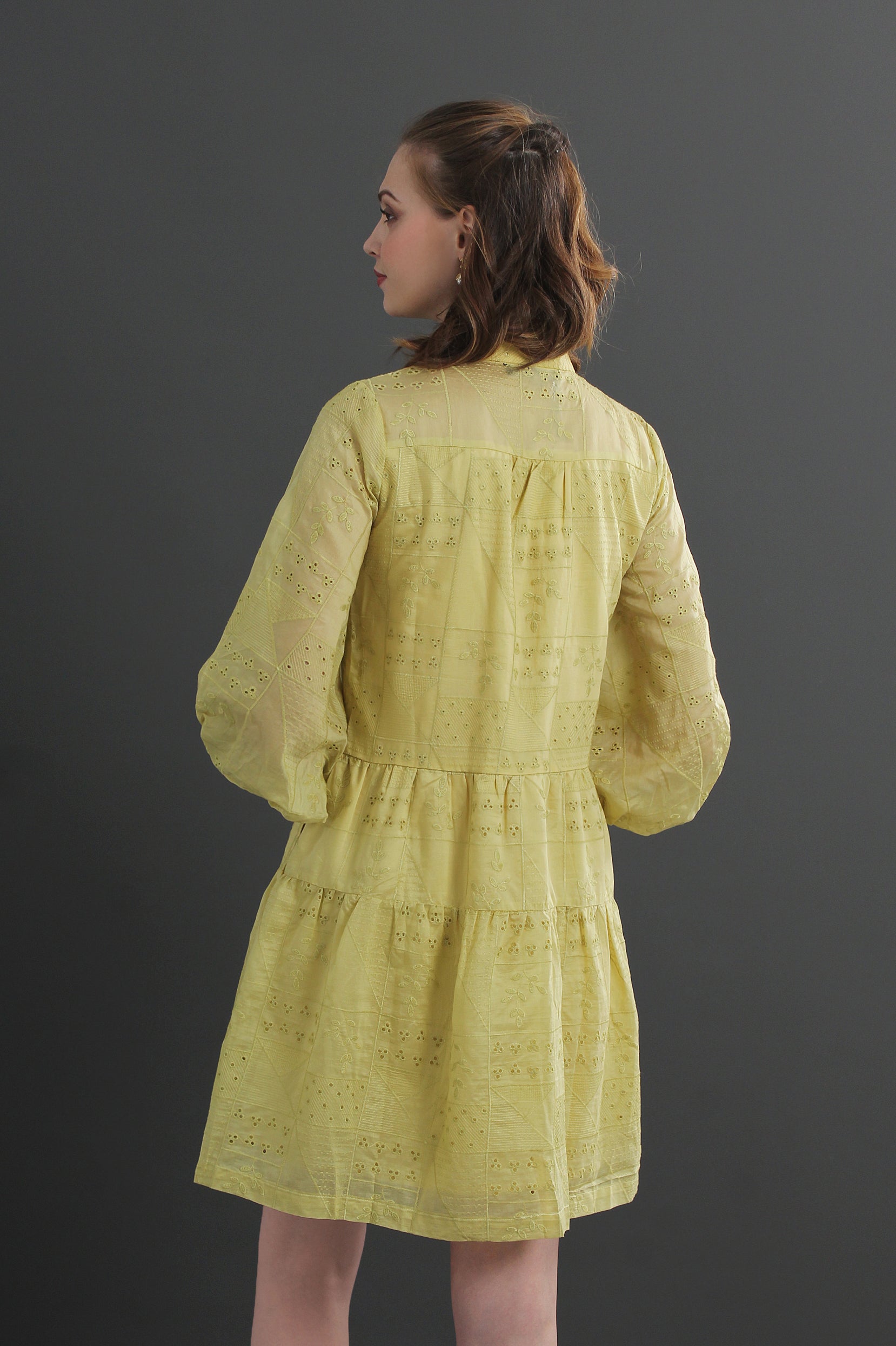 Woman wearing an eyelet yellow dress