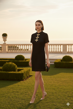 Black cheongsam with mandarin collar textured fabric with traditional gold frog closures with refined metallic braiding