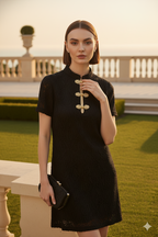 Black cheongsam with mandarin collar textured fabric with traditional gold frog closures with refined metallic braiding