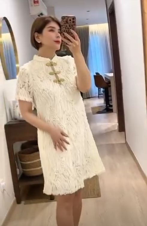 White cheongsam with mandarin collar textured fabric with traditional gold frog closures with refined metallic braiding