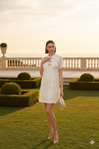 White cheongsam with mandarin collar textured fabric with traditional gold frog closures with refined metallic braiding