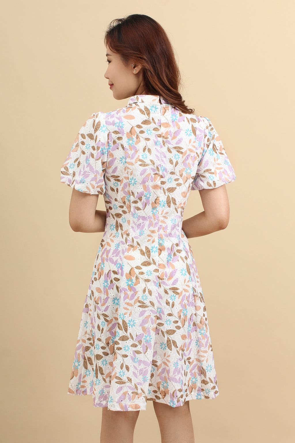 the back look of the purple floral printed mini dress with that has cotton eyelet and short puff sleeves