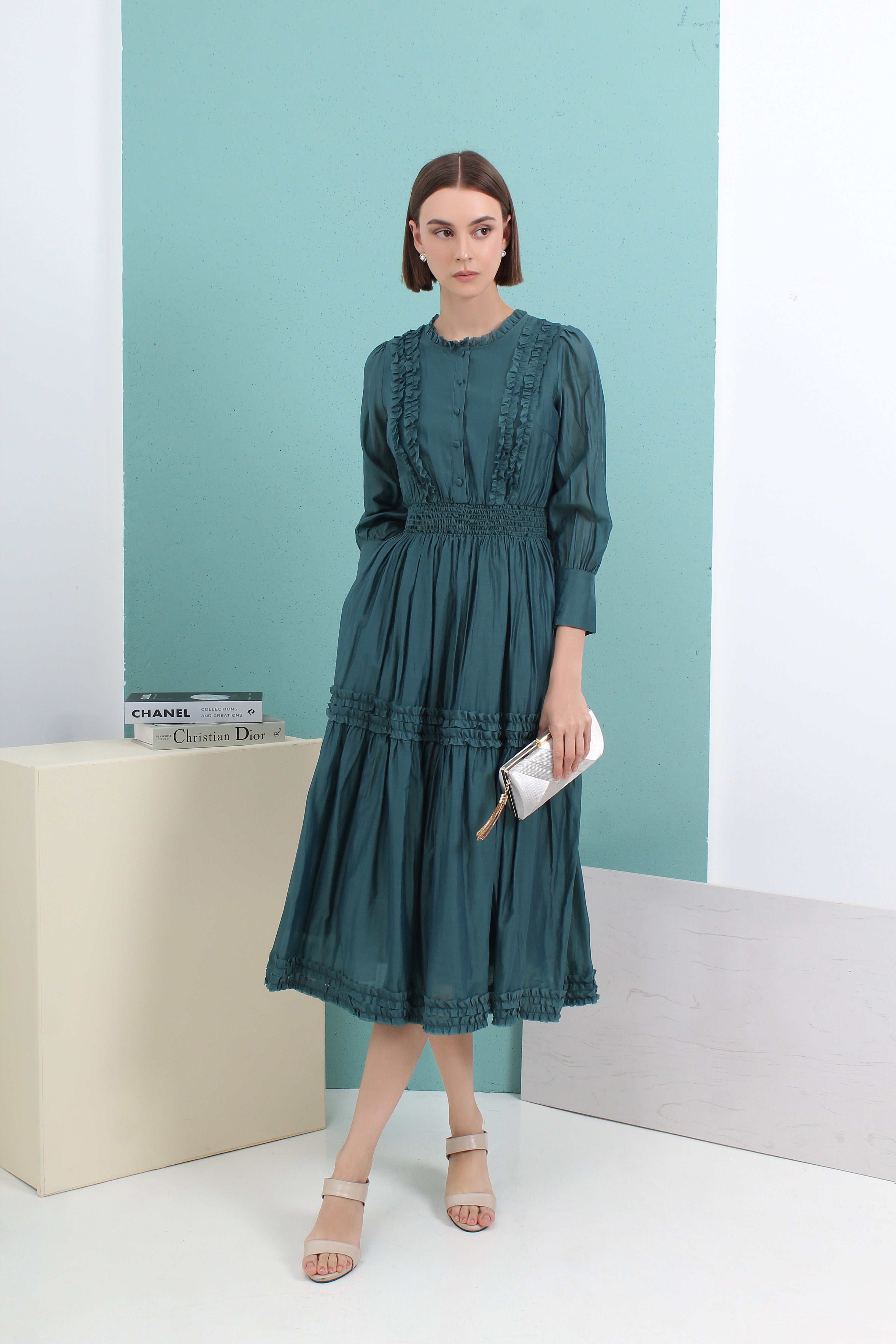 Woman wearing a green dress by le ann maxima malaysian local fashion brand